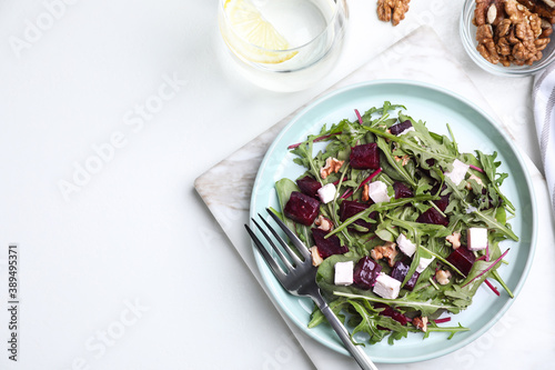 Fresh delicious beet salad on white table, flat lay. Space for text