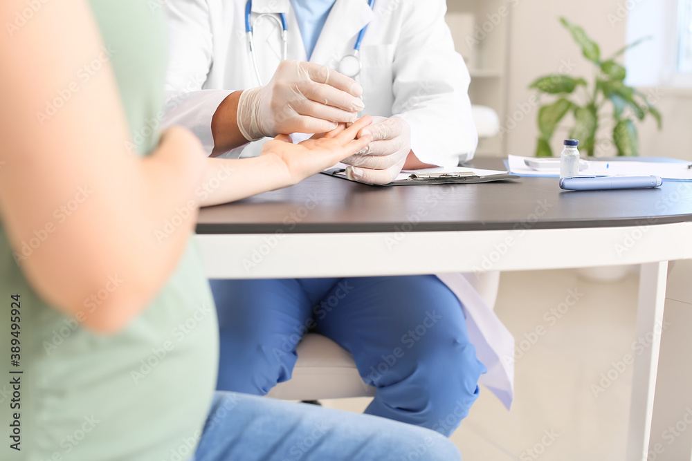 Pregnant diabetic woman visiting doctor in clinic Pregnant diabetic woman visiting doctor in clinic