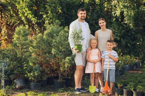 Happy young family in green...