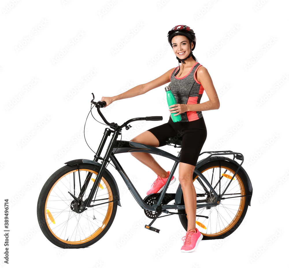 Naklejka premium Female cyclist drinking water on white background