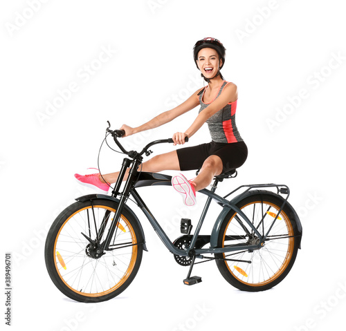 Female cyclist riding bicycle on white background © Pixel-Shot