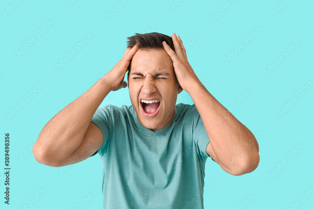 Fototapeta premium Stressed young man on color background