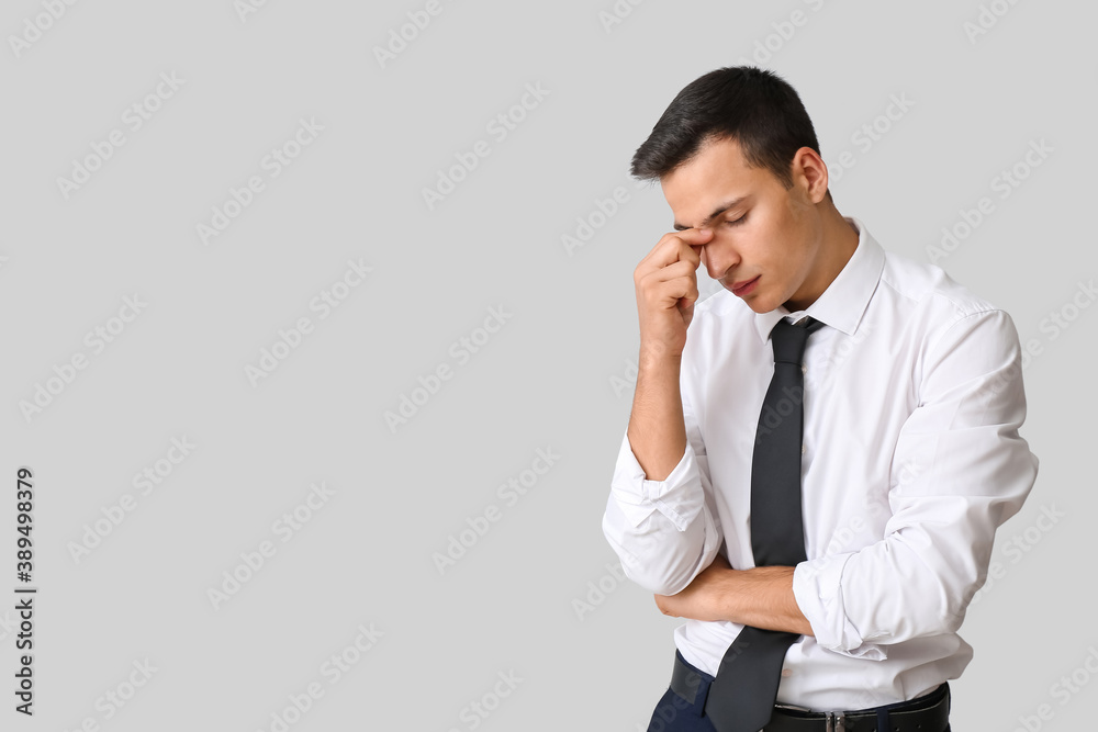 Stressed young businessman on light background Stressed young businessman on light background