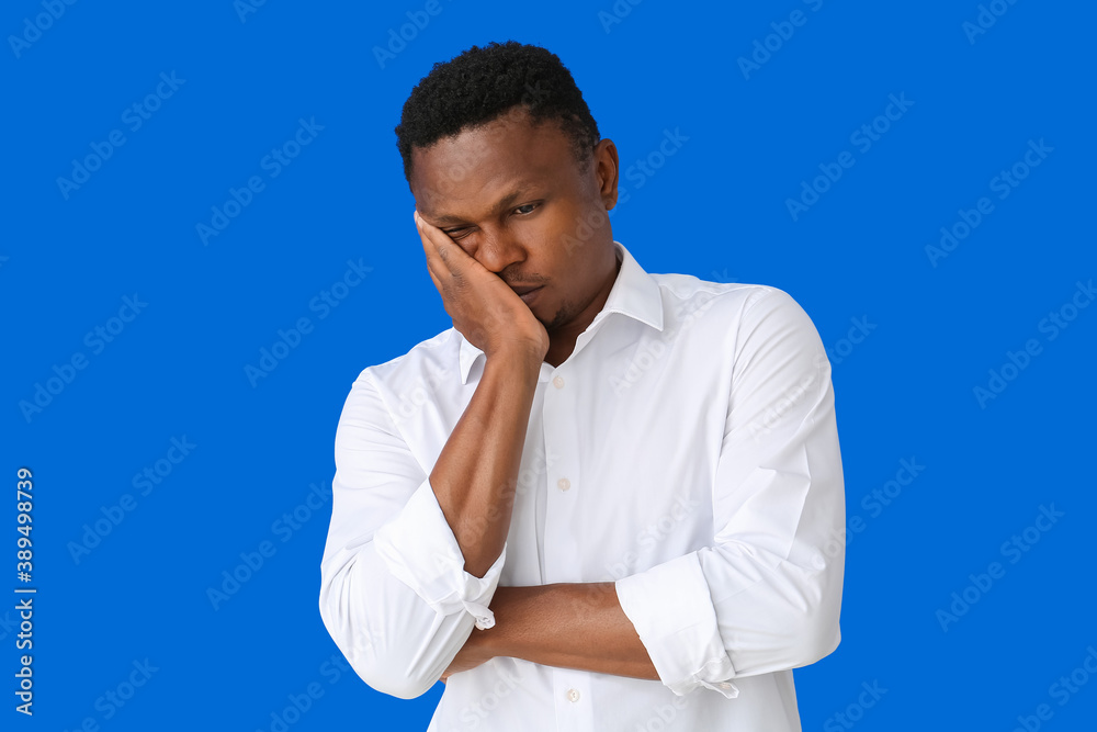 Stressed African-American man on color background Stressed African-American man on color background