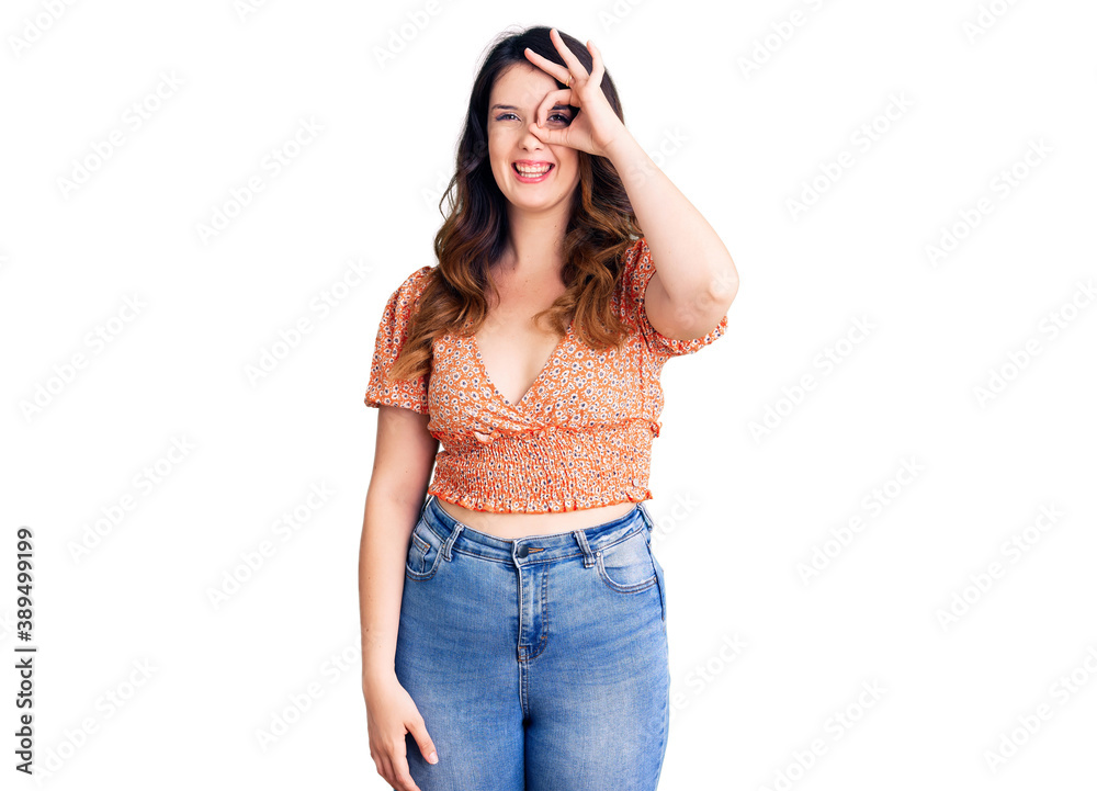 Beautiful young brunette woman wearing casual clothes doing ok gesture with hand smiling, eye looking through fingers with happy face. Beautiful young brunette woman wearing casual clothes doing ok gesture with hand smiling, eye looking through fingers with happy face.