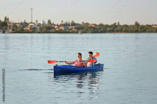 Young couple kayaking in river