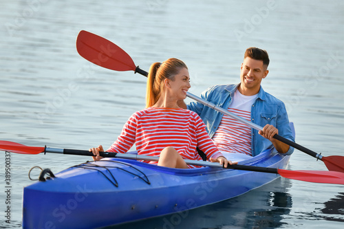 Young couple kayaking in river