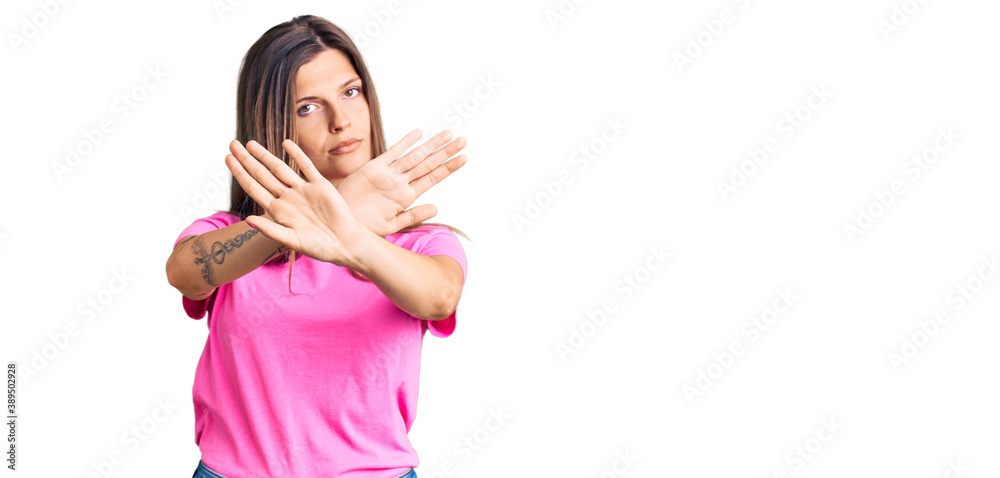 Beautiful caucasian woman wearing casual clothes rejection expression crossing arms and palms doing negative sign, angry face Beautiful caucasian woman wearing casual clothes rejection expression crossing arms and palms doing negative sign, angry face