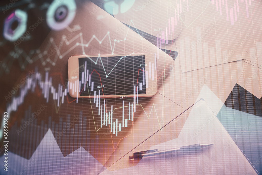 Multi exposure of forex graph hologram over desktop with phone. Top view. Mobile trade platform concept. Multi exposure of forex graph hologram over desktop with phone. Top view. Mobile trade platform concept.