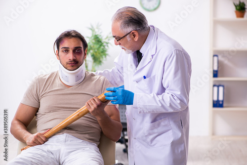 Young face injured man visiting experienced male doctor traumato