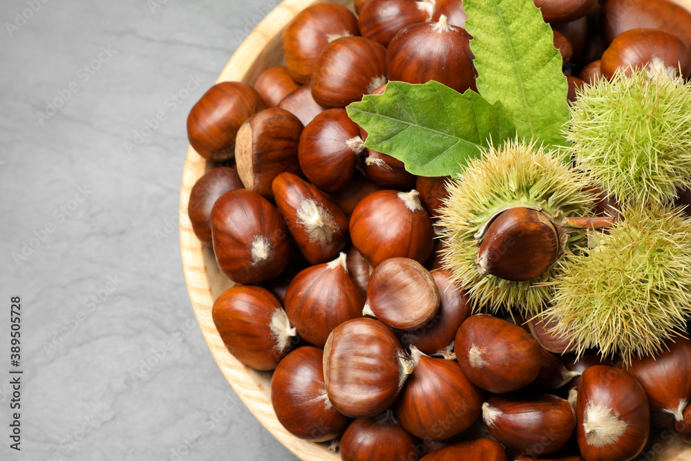 Fresh sweet edible chestnuts on black slate table, top view Fresh sweet edible chestnuts on black slate table, top view