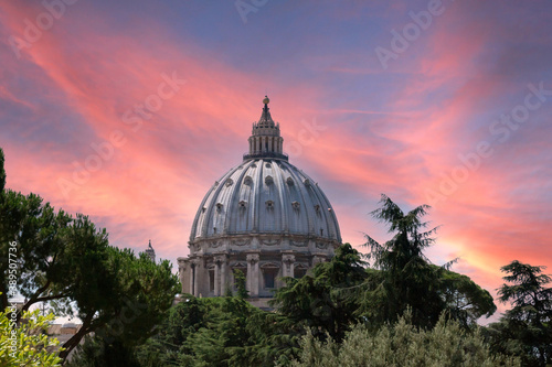 The st peters basilica catholic church dome in rome italy during sunset and pink skies. Travelling and architecture concept.
