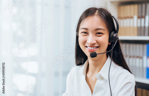 Asian business woman wear headset and working on telemarketing with online customer support.