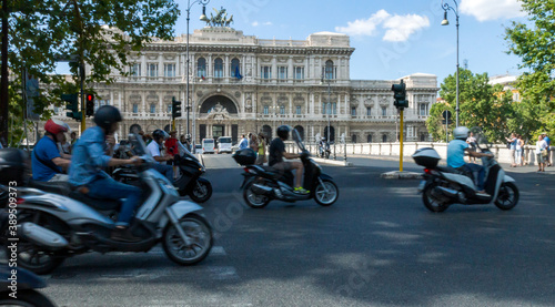 Scooters and tourists in the city of rome, corte di cassazione supreme court in the background. photo