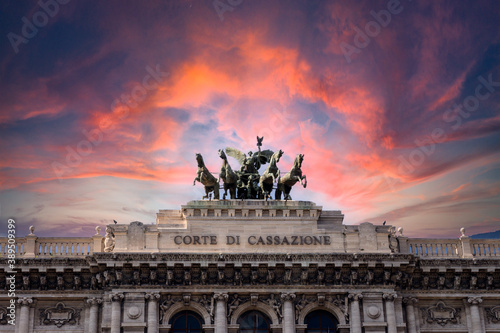 Photography Pink dramatic skies during sunset over the bronze horses at corte di cassazione supreme court in Rome, italy