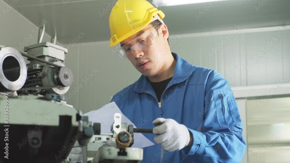 Asian mechanical workers working on milling machine with carefully. Asian mechanical workers working on milling machine with carefully.