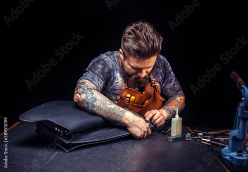Leather workman produces a good product at his studio photo