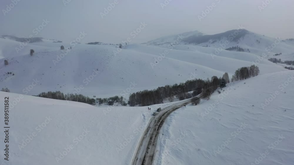 Aerial video of winter road and trees under snow in Altai. Siberia, Russia Aerial video of winter road and trees under snow in Altai. Siberia, Russia