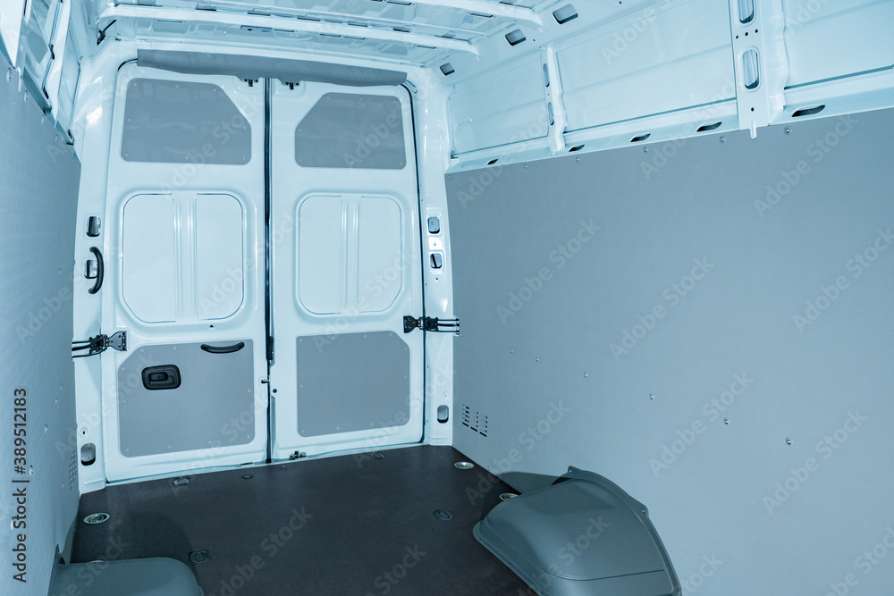 Empty cargo van inside view. Paneling of new van. Cargo department of a
