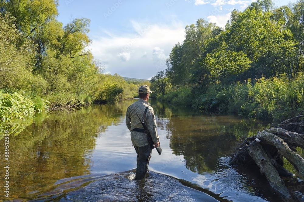 Fisheries Inspector controls order on the spawning taiga river. Iska river. Khabarovsk Krai, far East, Russia. Fisheries Inspector controls order on the spawning taiga river. Iska river. Khabarovsk Krai, far East, Russia.