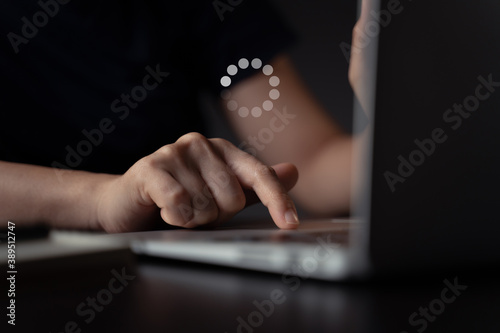 Woman using laptop and icon loading hologram effect.