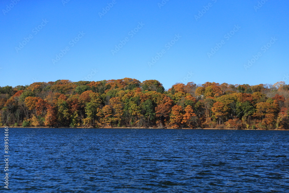 Trees in autumn colors reflect surrounding Lake Gleneida in Putnam County, New York. Trees in autumn colors reflect surrounding Lake Gleneida in Putnam County, New York.