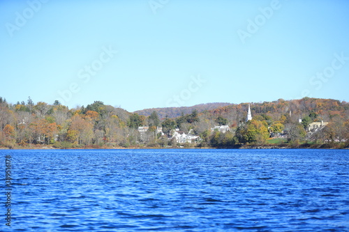 Trees in autumn colors reflect surrounding Lake Gleneida in Putnam County, New York.