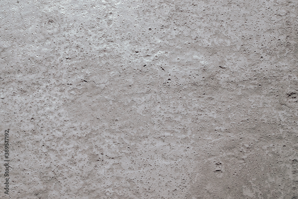 Obraz premium A close-up of a beige surface made of concrete, plaster, cement. Texture, background. Horizontal orientation, selective focus.