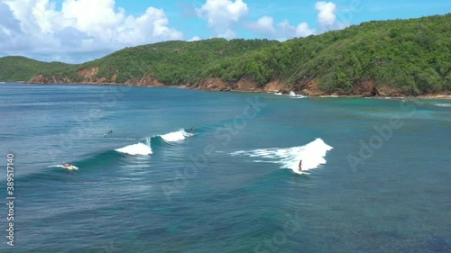 Woman surfing in Tartane Martinique best surf spot anse bonneville coral reef aerial shot 