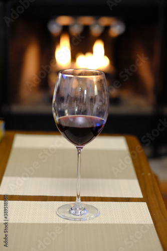 Glass of wine by the fireplace
