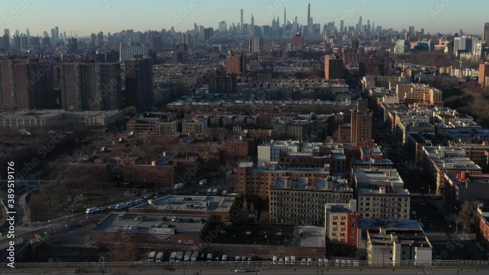 Aerial flight in the early morning in Upper Manhattan towards the skyline
