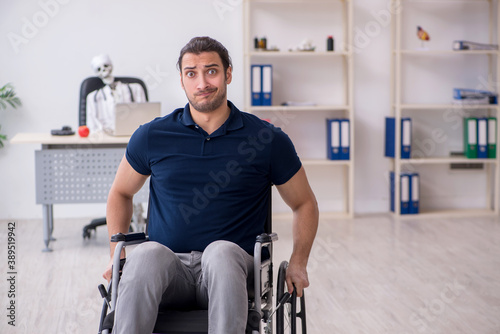 Young man in wheel-chair visiting dead doctor