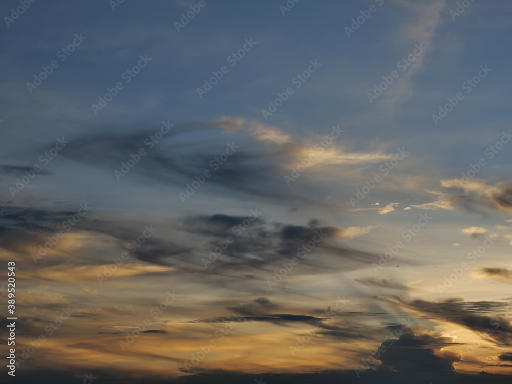 Cumulus cloud with sunbeam on beautiful blue sky at sunset , The horizon becomes orange and gold color at night , Fluffy clouds formations at tropical zone , Thailand