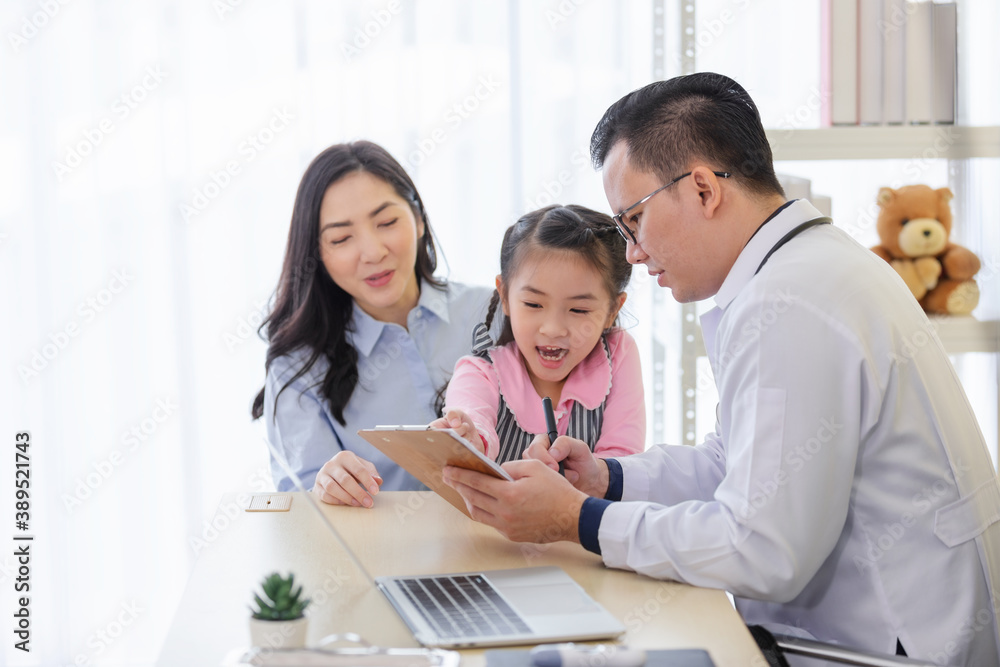 Pediatrician doctor describes the results of a physical examination to children and mother holding baby in her hands. Pediatrician doctor describes the results of a physical examination to children and mother holding baby in her hands.