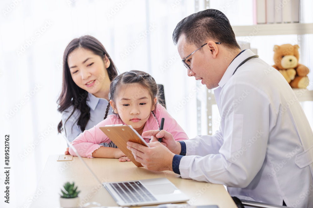 Pediatrician doctor describes the results of a physical examination to children and mother holding baby in her hands. Pediatrician doctor describes the results of a physical examination to children and mother holding baby in her hands.