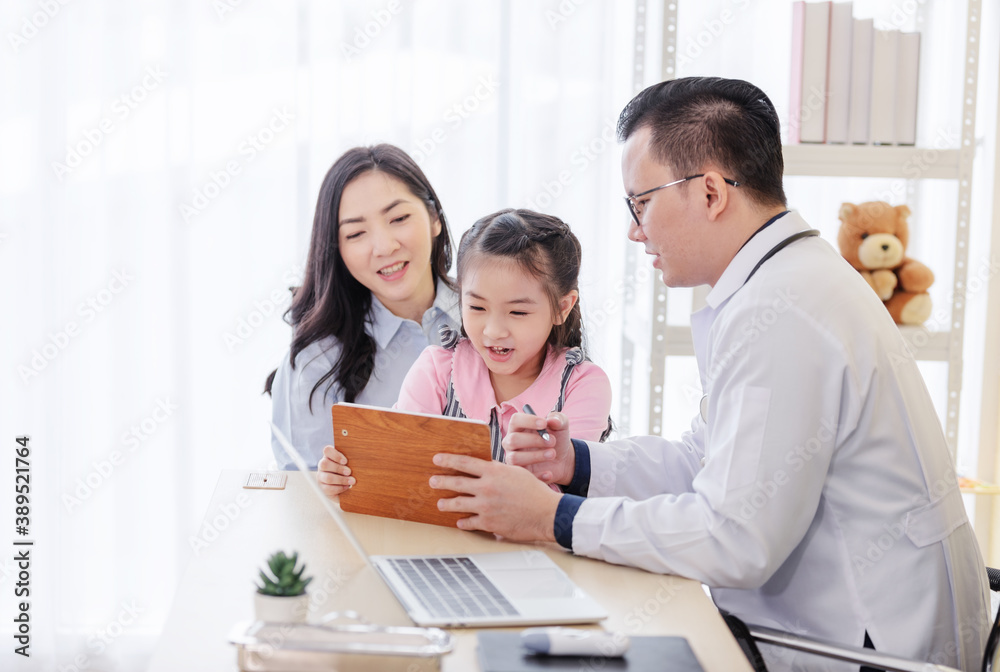 Pediatrician doctor describes the results of a physical examination to children and mother holding baby in her hands. Pediatrician doctor describes the results of a physical examination to children and mother holding baby in her hands.