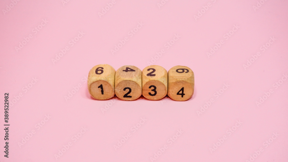 Wooden dice on pink background Wooden dice on pink background