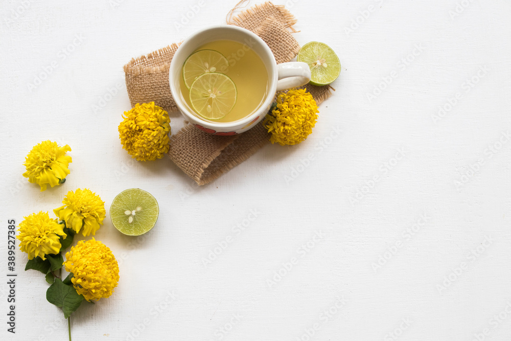 marigold yellow flower on sack with healthy drinks honey lemon for health care relax arrangement flat lay style on background white marigold yellow flower on sack with healthy drinks honey lemon for health care relax arrangement flat lay style on background white
