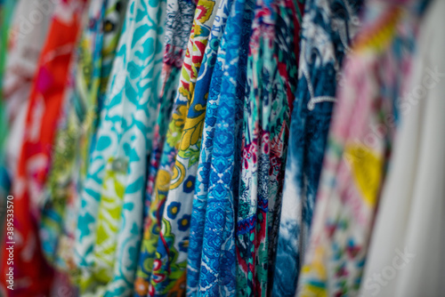 Selective focus on colorful material hanging on a rack