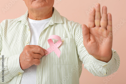 Mature man with pink ribbon...