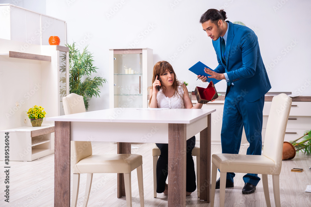Female owner and male police officer in housebreaking concept Female owner and male police officer in housebreaking concept