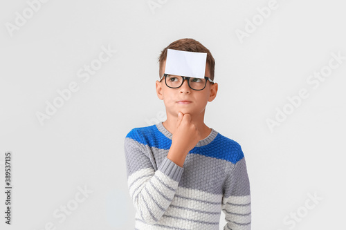 Thoughtful boy with blank n...