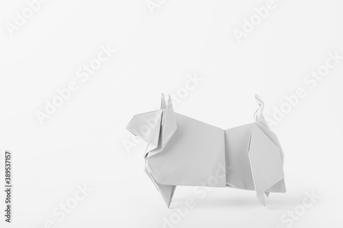 Origami bull as symbol of year 2021 on white background