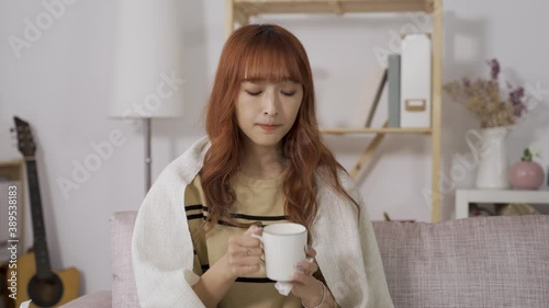 front view of Asian young lady lack of energy drinking lukewarm water, feeling tired and dizzy.