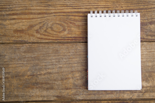 Notebook isolated on wooden background.
