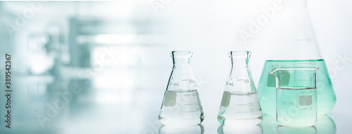 flask and beaker in chemistry science laboratory banner background