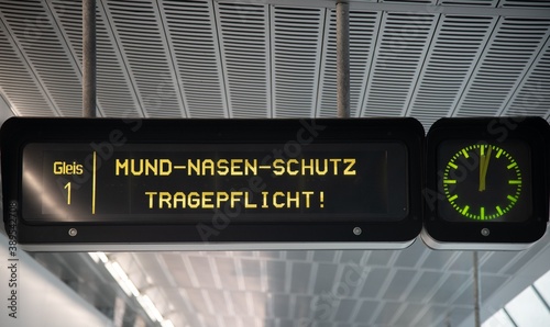 Photography face mask reminder on subway announcement board in Vienna