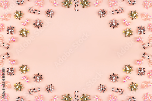 christmas or new year frame composition. christmas decorations in pink colors on pink background with empty copy space for text. holiday and celebration concept for postcard or invitation. top view