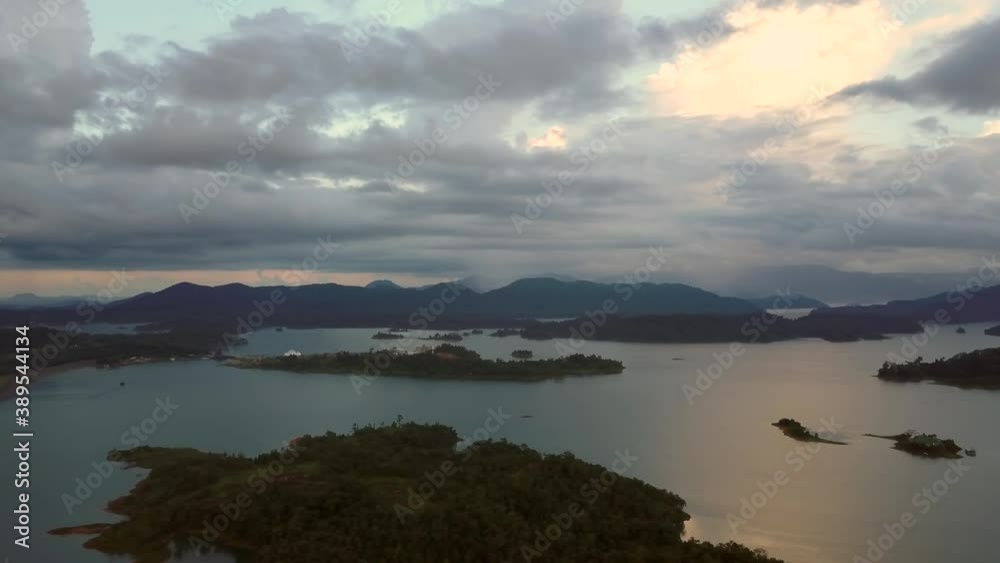 Golden sunrise rotating aerial view of the forest and island Kenyir Lake, Malaysia. Golden sunrise rotating aerial view of the forest and island Kenyir Lake, Malaysia.