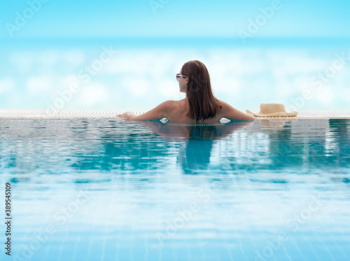 Woman relaxing in swimming pool © karandaev